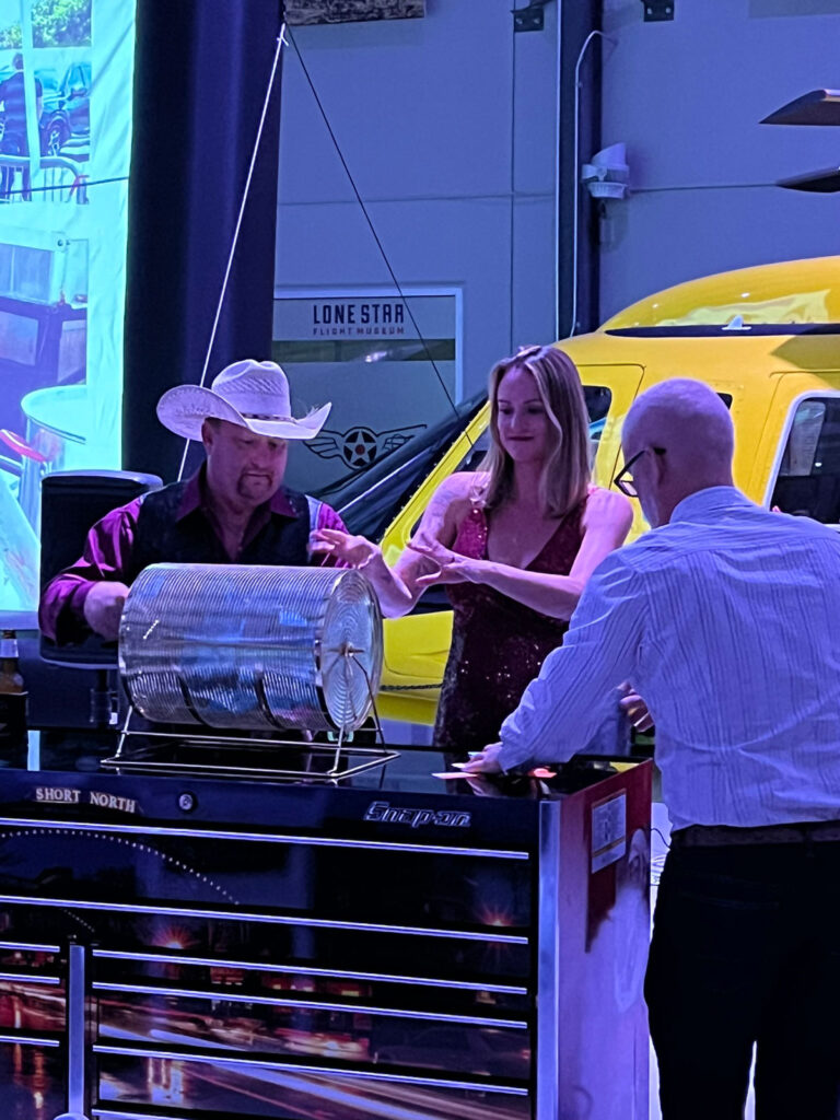 Jennifer Gamon, CEO of CAPS Aviation, draws the winning ticket for the custom Snap-on toolbox at the South Texas PAMA Gala